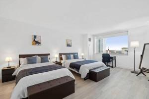 a hotel room with two beds and a window at CozySuites at Showboat Bold 2BR 3BA Beachfront in Atlantic City +33 photos
