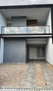 a building with a balcony on the side of it at Sobrado Home beach, 4 suites, piscina privativa e conforto expecional in Piçarras