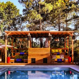 a wooden gazebo next to a swimming pool at Chalet - Piscine - ef0aac in Porto-Vecchio
