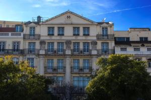 a large building with balconies on the side of it at Hotel Metropole in Lisbon