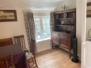 a dining room with a table and a window at The Plover in Blakeney