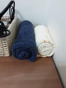 two towels and a basket on a table at Camp Humphreys pyeongtaek's sharing house in Pyeongtaek