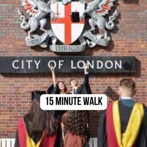 a city of london minute walk sign with people at Chapel Manor Large 2 Bed Flat Zone 1 in London