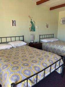 Midtown Inn & Suites في La Junta: سريرين في غرفة مع سريرين sidx sidx sidx