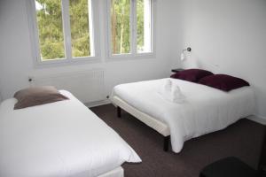 Ένα ή περισσότερα κρεβάτια σε δωμάτιο στο Le Bistroquet