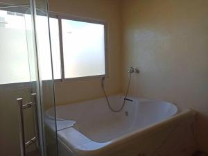 a bath tub in a bathroom with a window at Apt con vista al Mar 1Br-1Bath in La Romana
