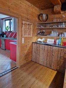 a kitchen with wooden walls and a counter top at Panorama-Ferienhaus im Stubaital in Mieders