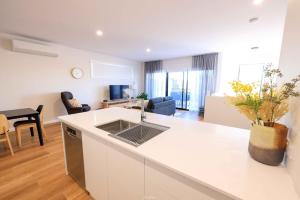a kitchen and living room with a couch and a table at Neddidge in Albury