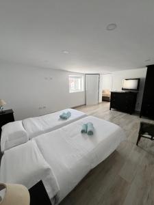 a bedroom with a large white bed with towels on it at Salobre Blue Sky 2 in Salobre +10 photos