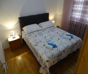 a bedroom with a bed with two pillows on it at Apartment-Roncevic-2-mit-Meeresblick in Slavonski Brod