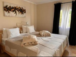 a bedroom with two beds and a window at Casa Baleares TS SL in Cala Santanyi