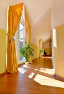 a room with yellow curtains and a large window at Hotel Zehnthof in Cochem