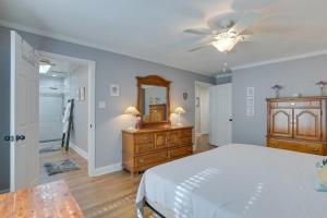 a bedroom with a bed and a dresser and a mirror at Lakefront Radford Home with Wraparound Deck! in Radford
