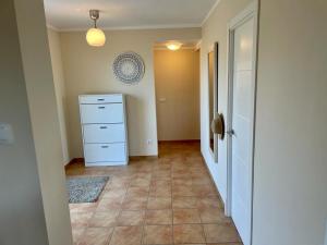 an empty room with a white dresser and a hallway at Casa Baleares TS SL in Cala Santanyi +16 photos