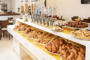 a buffet of breads and pastries on display at Hotel Minerva in Siena