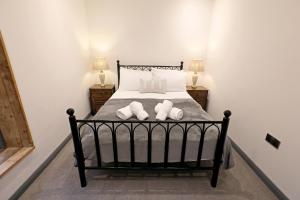 a bedroom with a bed with two towels on it at The Old Corn Store Rural Escape Farmstay Barn in Norwich