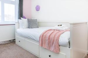 a white bedroom with a bed with white cabinets at Gardened 2BR house, quiet Cul-de-Sac of Wembley in Preston