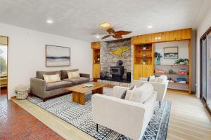 a living room with a couch and a table at Pokey Moonshine in Springwater