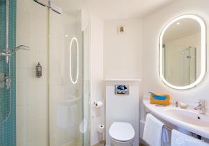 a bathroom with a toilet and a sink and a shower at ibis Lyon Sud Vienne Saint-Louis in Vienne