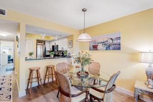 a dining room and kitchen with a glass table and chairs at Sunset Terrace in Avon