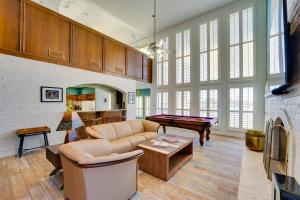 a living room with a couch and a pool table at Waterfront Haven Padre Island Home with Swim Spa! in Padre Island