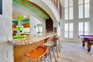 a kitchen with a bar with a ping pong table at Waterfront Haven Padre Island Home with Swim Spa! in Padre Island