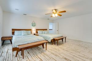 a bedroom with two beds and a ceiling fan at Waterfront Haven Padre Island Home with Swim Spa! in Padre Island +30 photos