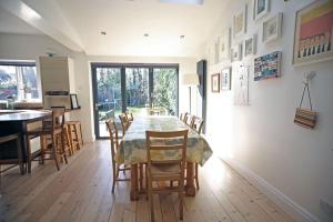 a kitchen and dining room with a table and chairs at Spacious and bright 4 bed home in vibrant Chorlton in Manchester