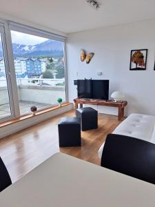 a living room with a bed and a large window at Lo de Moli 5A in Ushuaia