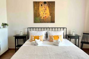 a bedroom with a bed with towels on it at Villa Oinoni in Egina