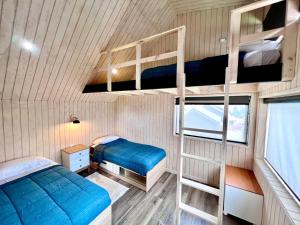 Postel nebo postele na pokoji v ubytování AncudLodge