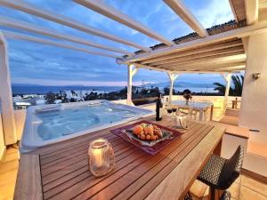 a deck with a hot tub on top of a house at Villa Pari Manda in Agios Prokopios