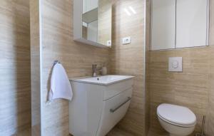a bathroom with a white sink and a toilet at Villa Delux View in Komarna +36 photos