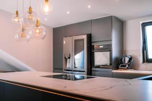 a kitchen with black cabinets and a counter top at Luxusapartment in Backnang mit Wellness in Backnang