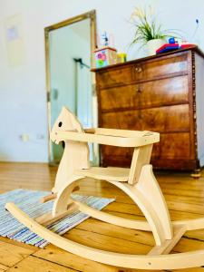 a wooden rocking chair sitting on a wooden floor at Cityhouse Nauwies in Saarbrücken