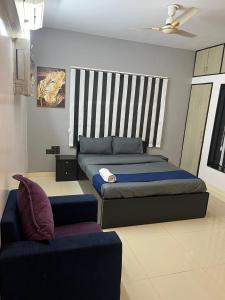a bedroom with a large bed and a couch at Fully Furnished Luxurious Terrace apartment in Pune