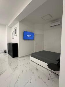 Habitación con cama y TV en la pared. en Cernusco luxury Milanese apartment, en Cernusco sul Naviglio