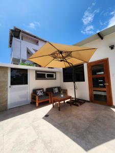 a large yellow umbrella sitting on a patio at CASA GALAPAGOS by Hostal Fragata in Puerto Ayora
