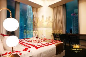 a bedroom with a bed with a tiara on it at Crown Suites Tropicana The Residence KLCC Bukit Bintang Kuala Lumpur in Kuala Lumpur