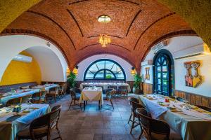 a restaurant with tables and chairs in a large room at Sonesta Nouba Hotel Aswan in Aswan