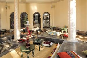 a living room with a couch and tables and chairs at Iberostar Selection Diar El Andalous in Port El Kantaoui