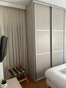 a bedroom with a bed and a sliding glass door at Athens Acropolis cozy apartment in Athens