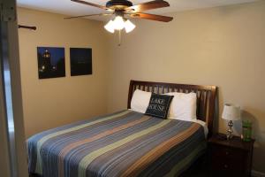 a bedroom with a bed with a ceiling fan at House # 49 No Wake Zone (no pets) in Centre