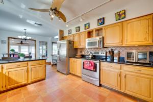 uma cozinha com armários de madeira e electrodomésticos de aço inoxidável em Spacious Apopka Escape with 1-Acre Backyard and Gym em Orlando