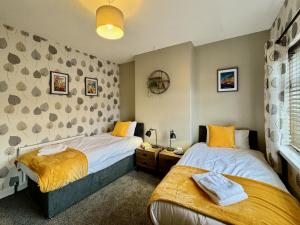 a bedroom with two beds and a window at Freeston House - Charm Townhouse in Cleethorpes