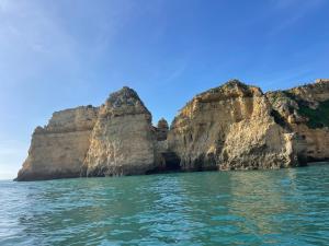 a view of cliffs from a boat in the water at Lagos Fly & Sea View Apartment in Lagos