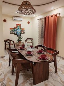 - une salle à manger avec une table et des chaises en bois dans l'établissement Le Deborah_Palace, à Lomé