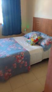 a bedroom with two beds with a blue comforter at Hospedaria Meu Lar in Rio das Ostras