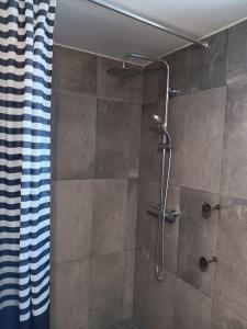 a bathroom with a shower with a shower curtain at Sunny Aljezur da Viana, (Aljezur, Costa Vicentina) in Aljezur