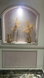 a shelf with two vases with flowers on it at Apartment for rent Zamalek in Cairo